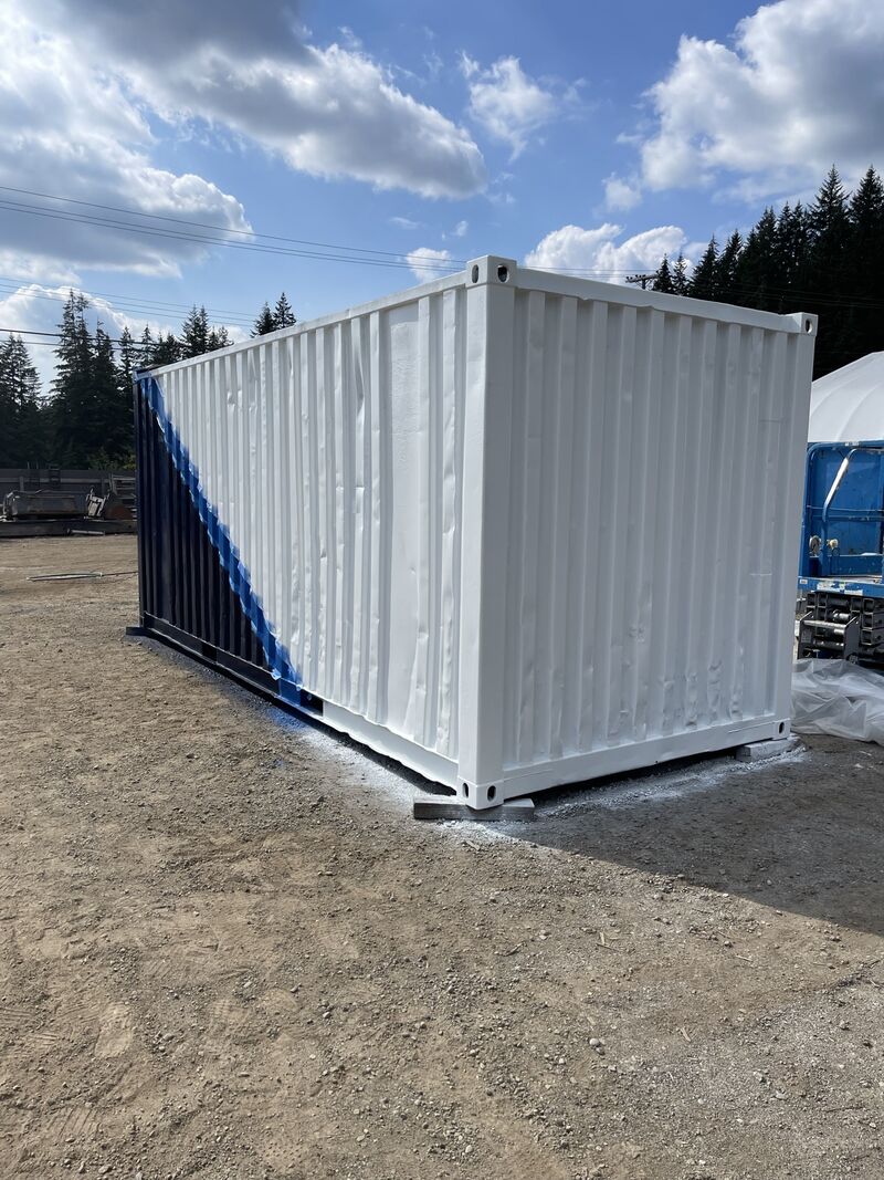 The finished container from the other corner: white sides with a navy and bright blue diagonal at the end.