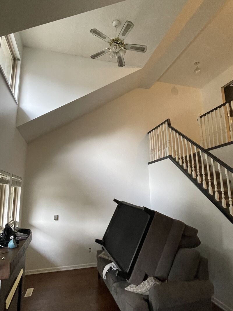After: the same stairwell wall repainted a light neutral.