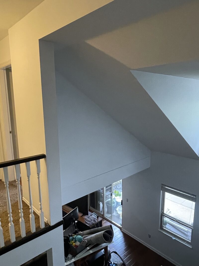 Looking down from the upper landing over the repainted stairwell.