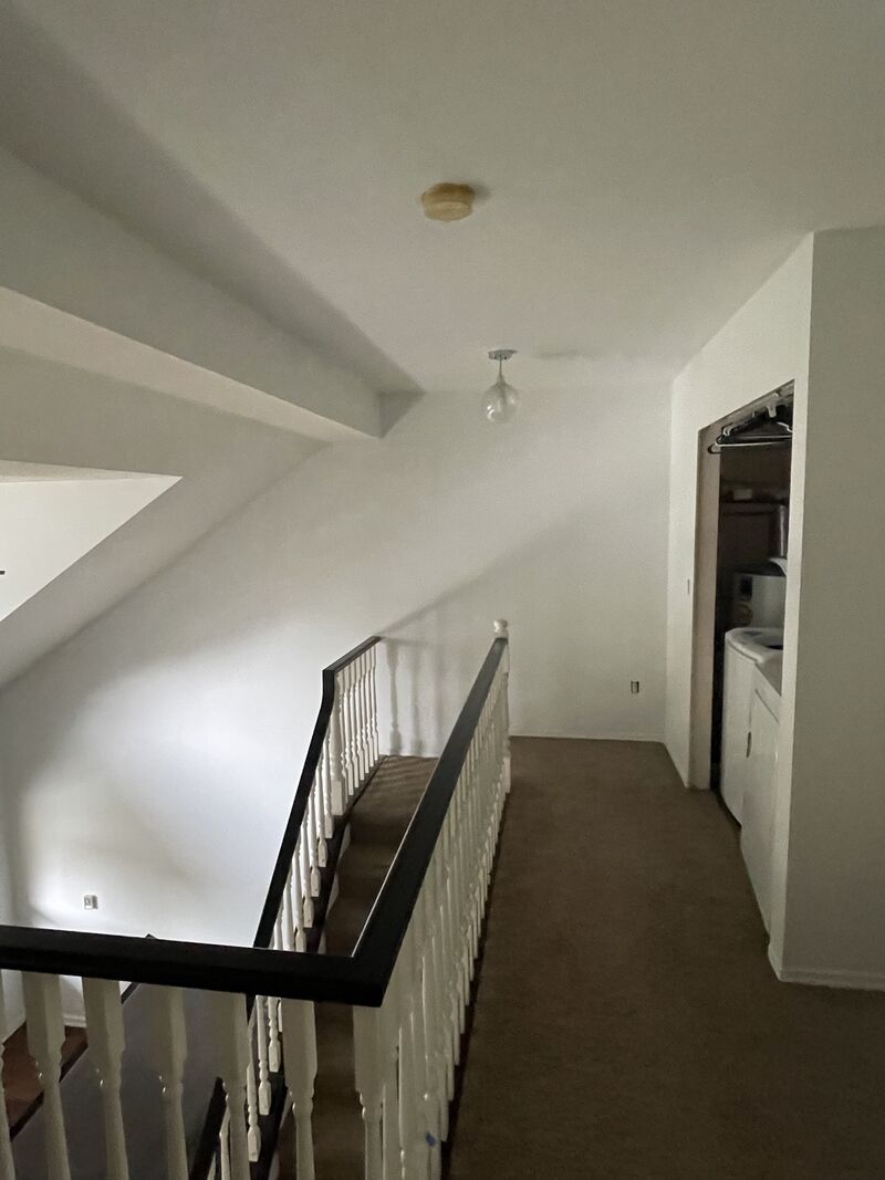 After: the same stair landing repainted a light neutral.