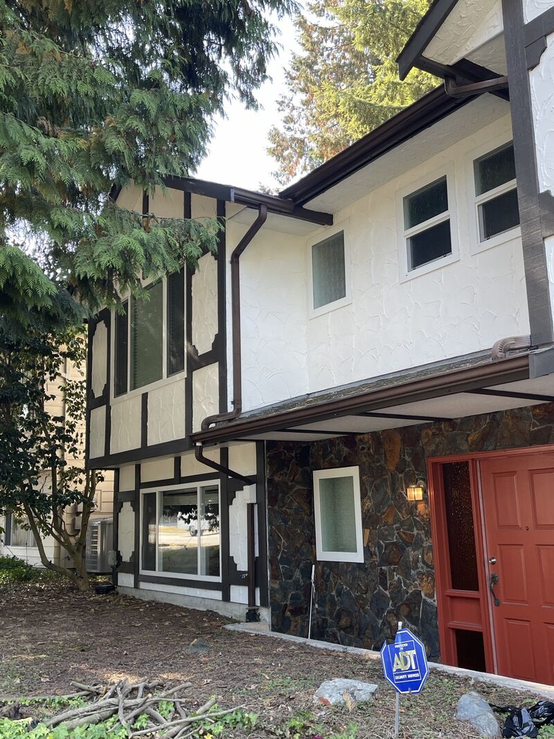 The front entry side of the house with the red door.