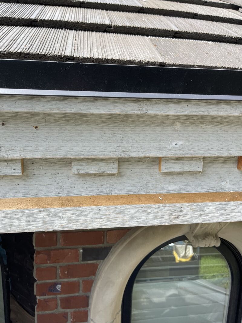 Trim and fascia above the brick and arched window.